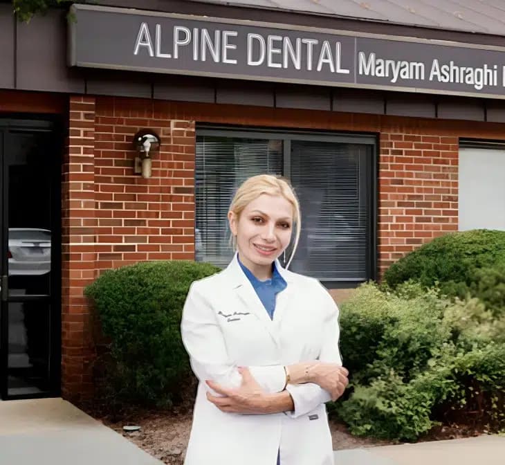 Dr. Maryam Ashraghi in her white coat outside the Alpine Dental office in Burke, VA